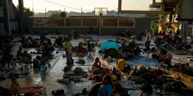 Migrants take temporary shelter in a basketball court in Juan Rodriguez Clara, Veracruz state, Mexico, on Wednesday, Nov. 24, 2021.