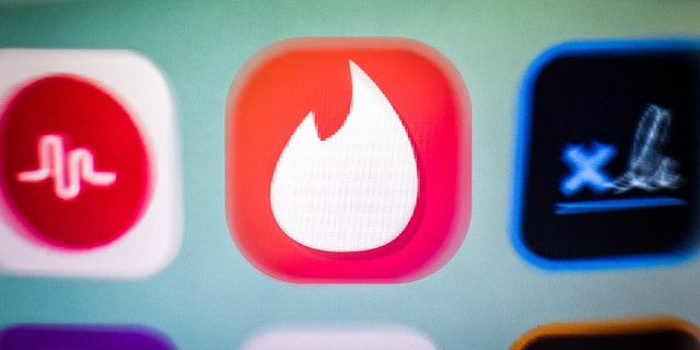 In this photo illustration, a Tinder app icon is displayed among other apps on a smartphone screen. 