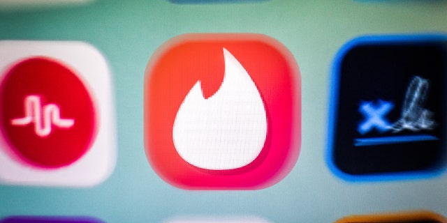 In this photo illustration, a Tinder app icon is displayed among other apps on a smartphone screen. 