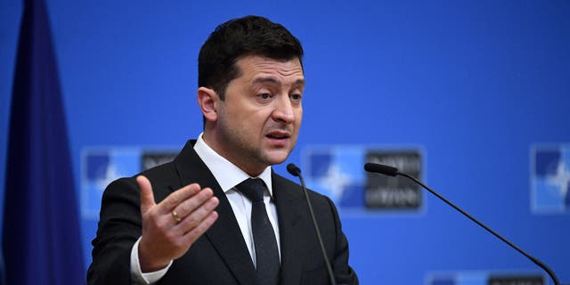 Ukrainian President Volodymyr Zelensky talks during a press conference in Brussels Dec. 16, 2021.