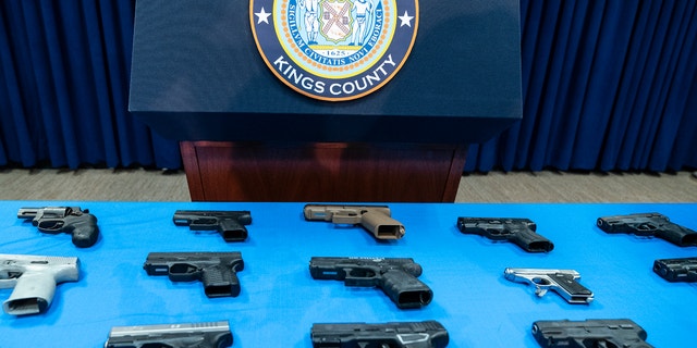 Guns confiscated from gang members on display during Brooklyn District Attorney Eric Gonzalez's press conference in the DA's office on Jan. 4, 2022. 