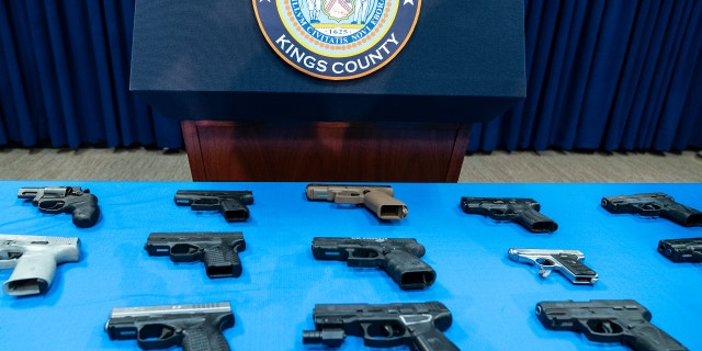 Guns confiscated from gang members on display during Brooklyn District Attorney Eric Gonzalez's press conference in the DA's office on Jan. 4, 2022. 