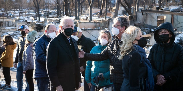 Joe Biden and first lady Jill Biden meet with victims as they tour a neighborhood destroyed by the Marshall Fire in Louisville, Colo., Jan. 7, 2022.