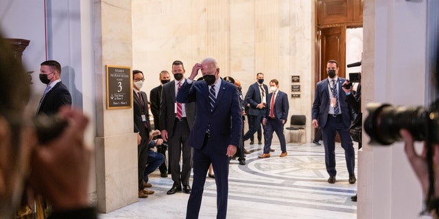 President Joe Biden exits a meeting with the Senate Democratic Caucus in Washington on Jan. 13, 2022.