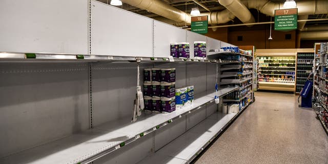 Toilet paper and paper towels shelves are seen empty at a supermarket in Miami Beach, Florida on January 13, 2022. (Photo by CHANDAN KHANNA / AFP) (Photo by CHANDAN KHANNA/AFP via Getty Images)