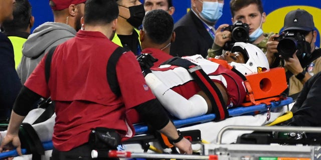 Cardinals Budda Baker, #3, is taken off the field after he suffered an injury as his head was tucked under Rams Cam Akers, #23, during fourth quarter action in the NFC Wild Card game at SoFi Stadium Monday, enero 17. 2022. The Rams defeated the Cardinals 34-11.