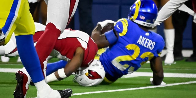 Cardinals Budda Baker, #3, suffered an injury as his head was tucked under Rams Cam Akers, #23, during fourth quarter action in the NFC Wild Card game at SoFi Stadium Monday, enero 17. 2022. The Rams defeated the Cardinals 34-11.   