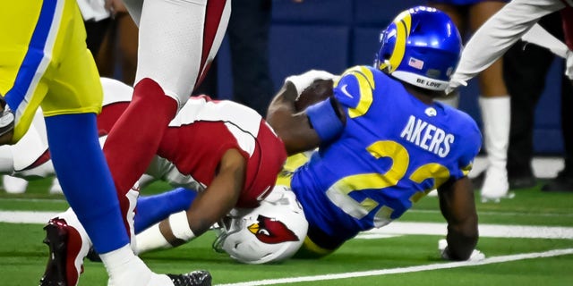 Cardinals Budda Baker, #3, suffered an injury as his head was tucked under Rams Cam Akers, #23, during fourth quarter action in the NFC Wild Card game at SoFi Stadium Monday, enero 17. 2022. The Rams defeated the Cardinals 34-11.
