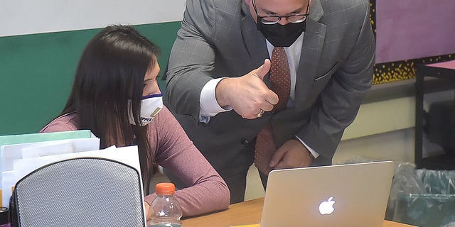 Education Secretary Miguel Cardona gives the thumbs up to virtual students in Danielle Shalon's seventh-grade math class at Beverly Hills Middle School in Upper Darby, Pennsylvania, on April 6, 2021.