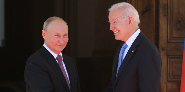 Russian President Vladimir Putin (L) greets US President Joe Biden (R) during the US - Russia Summit 2021 at the La Grange Villa near Lake Geneva, on June 16, 2021 in Geneva, Switzerland. (Mikhail Svetlov/Getty Images)