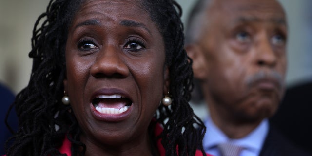 Civil rights leader Sherrilyn Ifill of the NAACP Legal Defense Fund speaks as the Rev. Al Sharpton of the National Action Network looks on at a news briefing outside the West Wing of the White House following a meeting with President Joe Biden and Vice President Kamala Harris July 8, 2021, in Washington, D.C. 