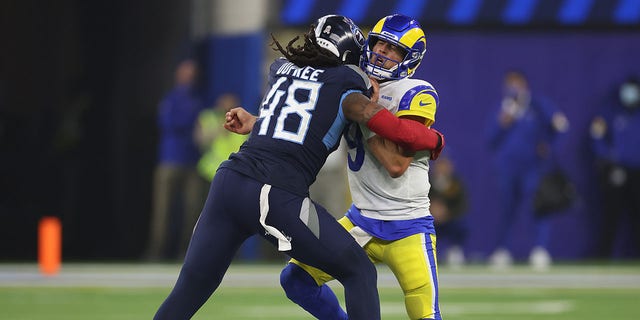 Matthew Stafford #9 of the Los Angeles Rams reacts as he is pressured by Bud Dupree #48 of the Tennessee Titans during the fourth quarter at SoFi Stadium on Nov. 7, 2021 in Inglewood, California.