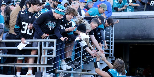 Trevor Lawrence of the Jaguars celebrates with fans following the Buffalo Bills game at TIAA Bank Field on Nov. 7, 2021, in Jacksonville, Florida.