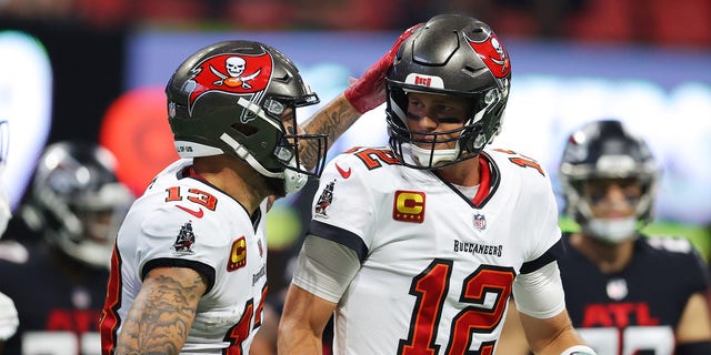 Tom Brady #12 of the Tampa Bay Buccaneers celebrates with Mike Evans #13 after a touchdown pass to Rob Gronkowski #87 during the second quarter against the Atlanta Falcons at Mercedes-Benz Stadium on Dec. 5, 2021 in Atlanta, Georgia.