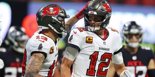 Tom Brady #12 of the Tampa Bay Buccaneers celebrates with Mike Evans #13 after a touchdown pass to Rob Gronkowski #87 during the second quarter against the Atlanta Falcons at Mercedes-Benz Stadium on Dec. 5, 2021 in Atlanta, Georgia.