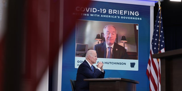 President Joe Biden listens as Gov. Asa Hutchinson speaks during a video call with the White House COVID-19 Response team and the National Governors Association at the Eisenhower Executive Office Building on Dec. 27, 2021 in Washington.