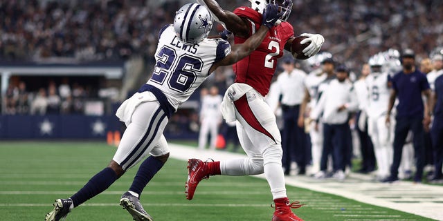 Chase Edmonds of the Arizona Cardinals runs the ball and looks to break a tackle by Jourdan Lewis of the Dallas Cowboys on Jan. 2, 2022 in Arlington, Texas. 