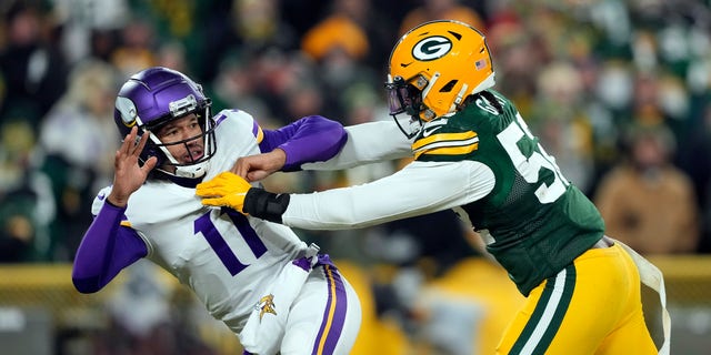 Quarterback Kellen Mond #11 of the Minnesota Vikings is hit by outside linebacker Rashan Gary #52 of the Green Bay Packers applies pressure during the 4th quarter of the game at Lambeau Field on Jan. 2, 2022 in Green Bay, Wisconsin. 