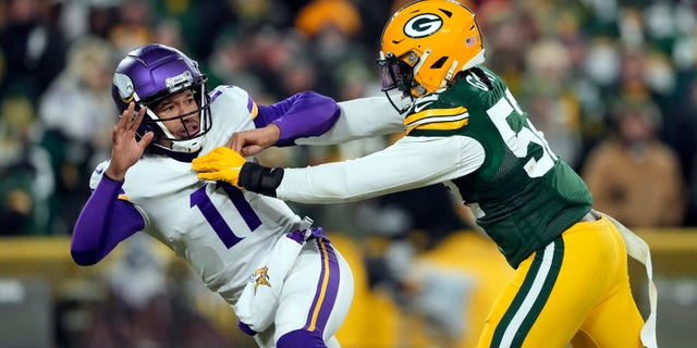 Quarterback Kellen Mond #11 of the Minnesota Vikings is hit by outside linebacker Rashan Gary #52 of the Green Bay Packers applies pressure during the 4th quarter of the game at Lambeau Field on Jan. 2, 2022 in Green Bay, Wisconsin.