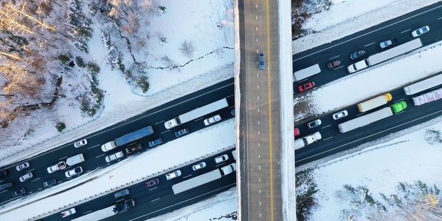STAFFORD COUNTY, VIRGINIA - JANUARY 04: In an aerial view, traffic creeps along Virginia Highway 1 after being diverted away from I-95 after it was closed due to a winter storm on January 04, 2022 near Fredericksburg in Stafford County, Virginia. (Photo by Chip Somodevilla/Getty Images)