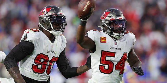 Lavonte David #54 of the Tampa Bay Buccaneers reacts with teammates after getting a fumble recovery in the fourth quarter against the Los Angeles Rams in the NFC Divisional Playoff game at Raymond James Stadium on January 23, 2022 in Tampa, Florida.