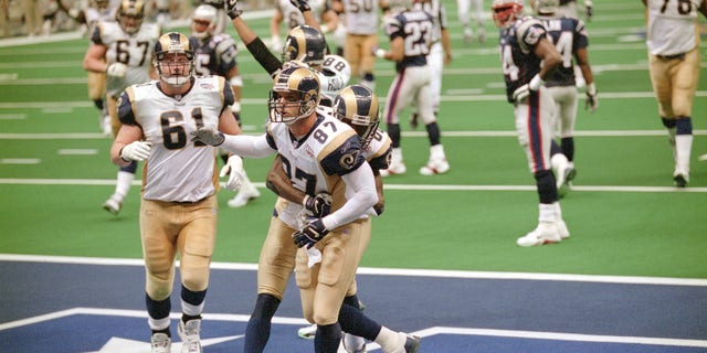 Ricky Proehl #87 and Isaac Bruce #80 of the St. Louis Rams celebrate after Proehl scored a touchdown against the New England Patriots during Super Bowl XXXVI at the Louisiana Superdome on Feb. 3, 2002 in New Orleans, Louisiana.  The Patriots won the game 20-17. 
