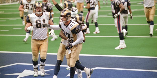 Ricky Proehl #87 and Isaac Bruce #80 of the St. Louis Rams celebrate after Proehl scored a touchdown against the New England Patriots during Super Bowl XXXVI at the Louisiana Superdome on Feb. 3, 2002 in New Orleans, Louisiana.  The Patriots won the game 20-17. 