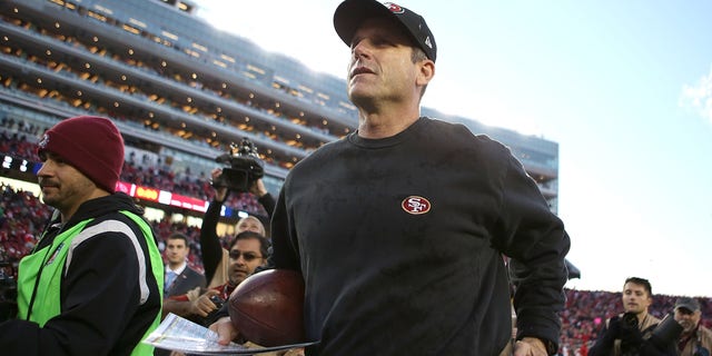 Head coach Jim Harbaugh leaves the field after the San Francisco 49ers' win over the Arizona Cardinals at Levi's Stadium on Dec. 28, 2014, in Santa Clara, California.  