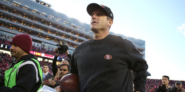 Head coach Jim Harbaugh leaves the field after the San Francisco 49ers' win over the Arizona Cardinals at Levi's Stadium on Dec. 28, 2014, in Santa Clara, California.