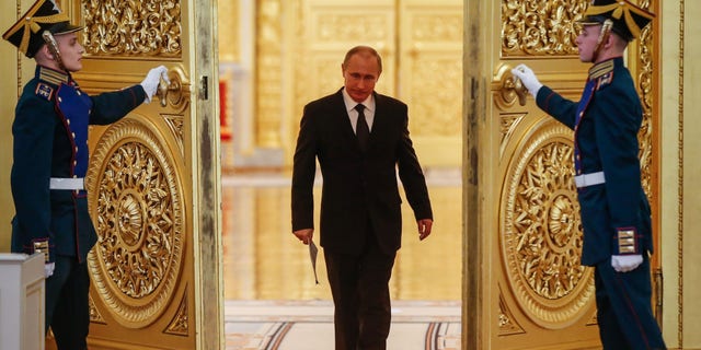 Russian President Vladimir Putin enters a hall before a meeting of the Victory Organizing Committee at the Kremlin in Moscow on March 17, 2015. The meeting focuses on preparations for celebrating the 70th anniversary of the victory in World War II. 