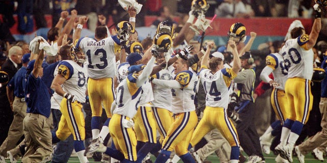 Rear view of St. Louis QB Kurt Warner (13) victorious on field after winning game vs Tennessee Titans at Georgia Dome. Atlanta, GA