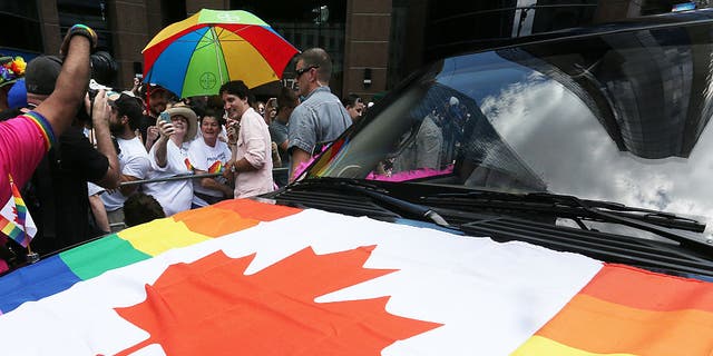 Canadian gay pride parade with Canada LGBT pride flag