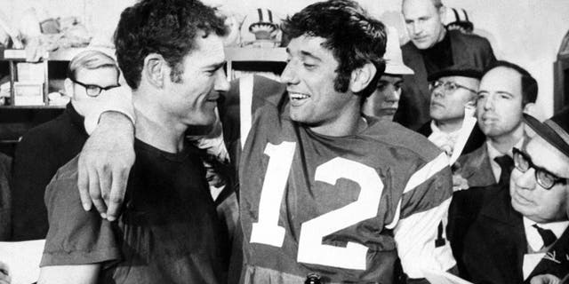New York Jets' Joe Namath (right) and Don Maynard are surrounded by reporters after winning the AFL Championship, 27-23, over the Oakland Raiders.