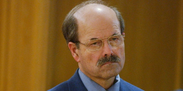 Serial killer Dennis Rader stands before Sedgwick County District Court Judge Greg Waller as sentencing is read Aug. 18, 2005, in Wichita, Kan. Rader was sentenced to nine life terms and a "hard 40" for the 10 murders he committed over nearly 30 years.  