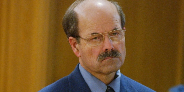 Serial killer Dennis Rader stands before Sedgwick County District Court Judge Greg Waller as sentencing is read Aug. 18, 2005, in Wichita, Kan. Rader received nine life terms and a "hard 40" for the 10 murders he committed over nearly 30 years.