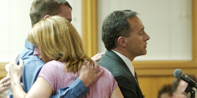 Brandon Wegerle (L) kisses his sister Stephanie Clyne as their father Bill Wegerle delivers a victim impact statement during the sentencing phase of the Dennis Rader murder trial at the Sedgwick County Courthouse on August 18, 2005 , in Wichita, Kan. Vicki Wegerle was one of 10 people killed by Rader.