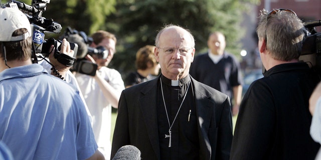 Reverend Michael Clark (center), pastor of Christ Lutheran Church, of which Dennis L. Rader was a member, walks by media outside the Sedgwick County Courthouse on the second day of sentencing, August 18 2005, in Wichita, Kan.