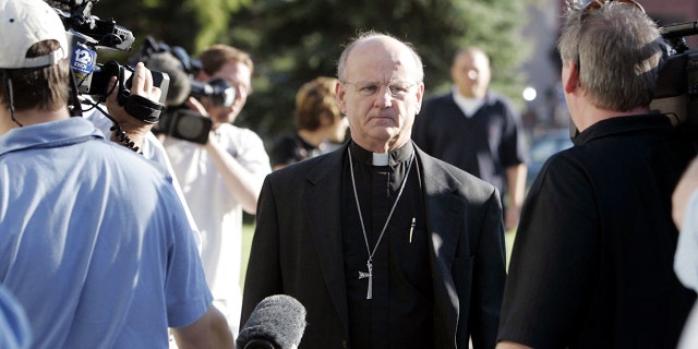 Reverend Michael Clark (center), pastor of Christ Lutheran Church, of which Dennis L. Rader was a member, walks by media outside the Sedgwick County Courthouse on the second day of sentencing, August 18 2005, in Wichita, Kan.