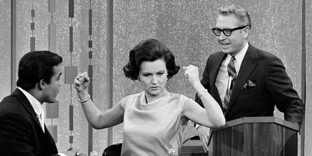 Unidentified guest contestant, Betty White and Allen Ludden on the game show ‘Password’.
