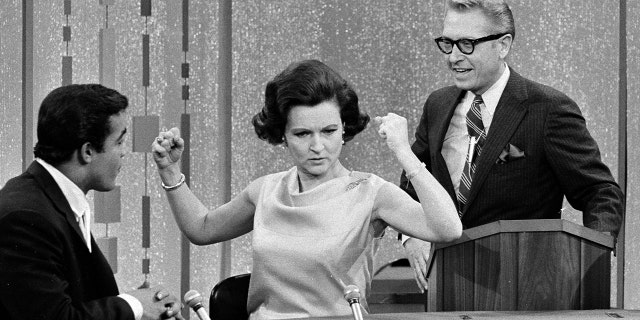 Unidentified guest contestant, Betty White and Allen Ludden on the game show ‘Password’.
