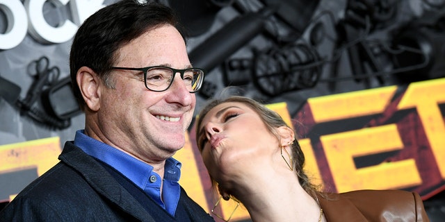 Bob Saget and Kelly Rizzo attend the red carpet premiere and party for Peacock's new comedy series 'MacGruber' at California Science Center on December 8, 2021, in Los Angeles, California.