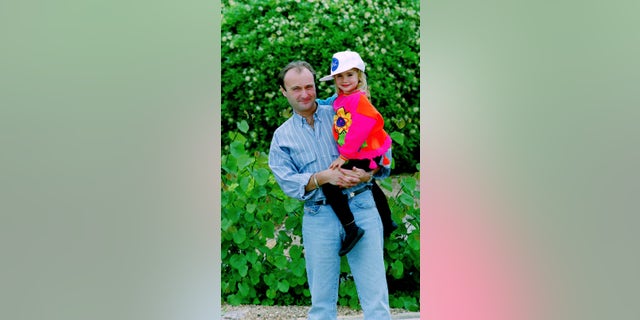Musician Phil Collins with daughter Lily Collins, while on tour in Japan, circa 1988.