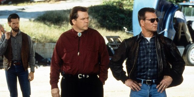 Meat Loaf and Patrick Swayze standing side by side in a scene from the film ‘Black Dog’.