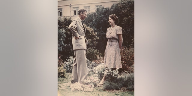 Princess Elizabeth, the future Queen Elizabeth II, conversing with her father, King George VI (1895 - 1952) in a garden, circa 1946.