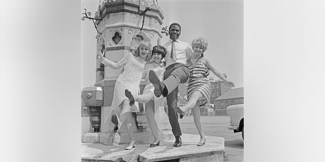 From left to right, actors Judy Geeson, Adrienne Posta, Sidney Poitier and Lulu on the set of the drama film ‘To Sir, With Love’.