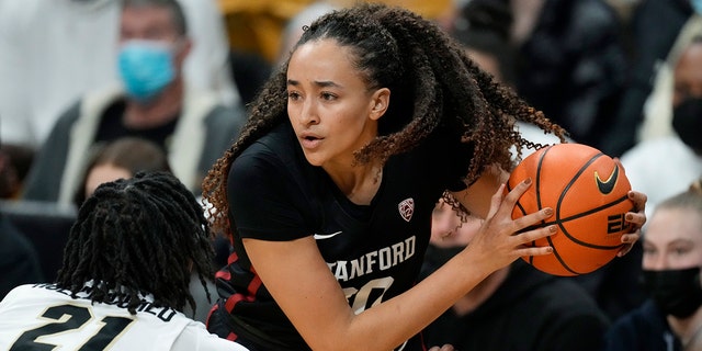 Stanford guard Haley Jones, right, looks to pass the ball as Colorado forward Mya Hollingshed defends in the first half of an NCAA college basketball game Friday, Jan. 14, 2022, in Boulder, Colo.
