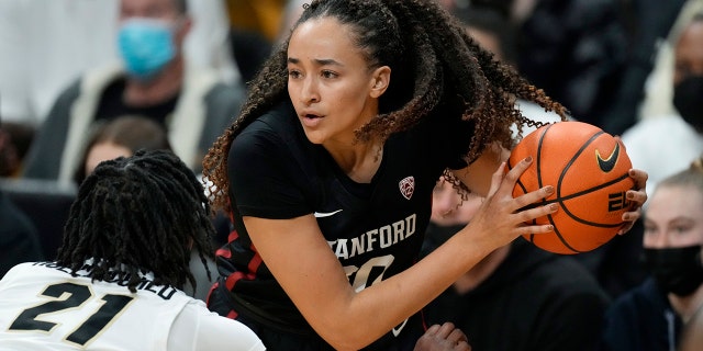 Stanford guard Haley Jones, right, looks to pass the ball as Colorado forward Mya Hollingshed defends in the first half of an NCAA college basketball game Friday, Jan. 14, 2022, in Boulder, Colo.