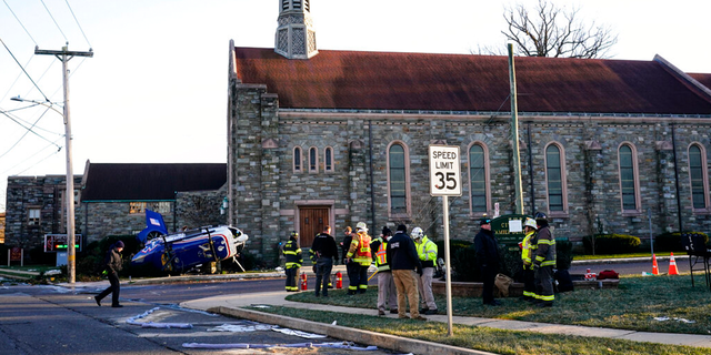 A medical helicopter rests next to the Drexel Hill United Methodist Church after it crashed in the Drexel Hill section of Upper Darby, Pa., on Tuesday, Jan. 11, 2022.