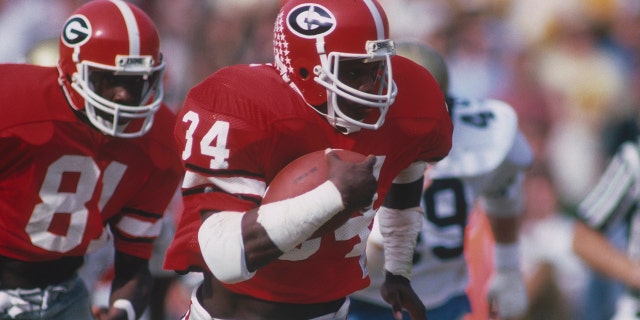 Georgia Bulldogs' running back Herschel Walker #34 runs with the ball during a circa 1980s game.
