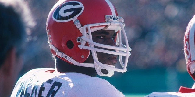 University of Georgia's running back Herschel Walker #34 looks over his shoulder from the sidelines during a game circa 1980-1982. Herschel Walker was elected to the College Football Hall of Fame in 1999. 